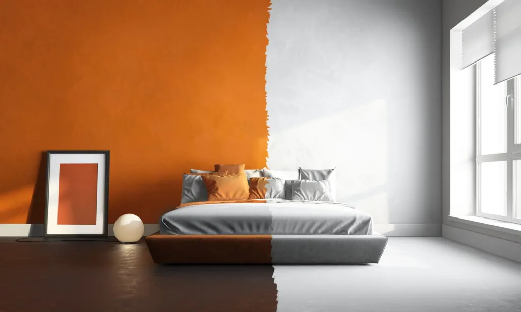 Bedroom wall half repainted in orange and half still white