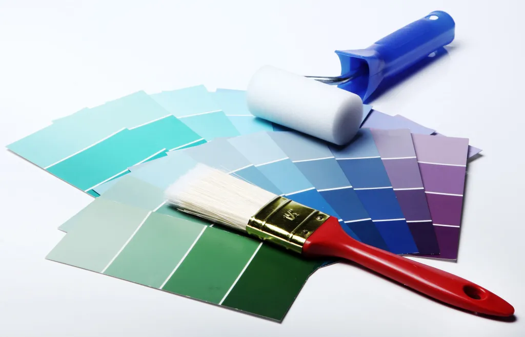 Fan of paint colour swatches with a brush and a roller