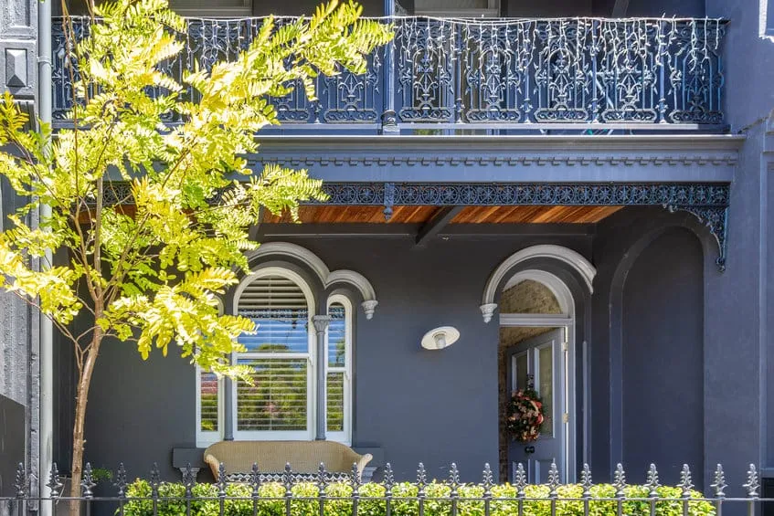 Painted terrace house with an iron lace balcony