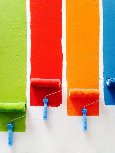 Green, red, orange and blue paint stripes applied with rollers